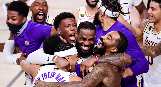 In this file photo taken on October 11, 2020, LeBron James (C) of the Los Angeles Lakers celebrates with teammates after winning the 2020 NBA Championship in Game Six at AdventHealth Arena in Lake Buena Vista, Florida. Douglas P. DeFelice / GETTY IMAGES NORTH AMERICA / AFP