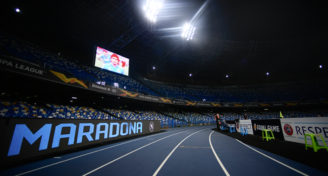 In this file photo taken on November 26, 2020 An homage to late Argentinian football legend Diego Maradona is displayed on a board (L) and on screen (Top L) prior to the UEFA Europe League Group F football match Napoli vs Rijeka on November 26, 2020 at the San Paolo stadium in Naples. Filippo MONTEFORTE / AFP