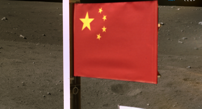 This picture taken and released on December 4, 2020, by the China National Space Administration (CNSA) via CNS shows a Chinese national flag unfurled from the Chang'e-5 lunar probe. China National Space Administration (CNSA) via CNS / AFP