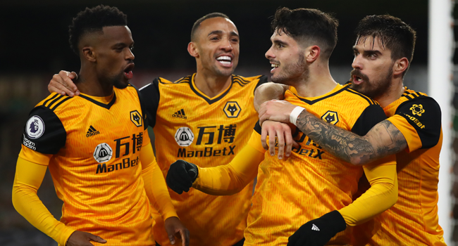 Wolverhampton Wanderers' Portuguese midfielder Pedro Neto (2R) celebrates scoring his team's second goal with teammates during the English Premier League football match between Wolverhampton Wanderers and Chelsea at the Molineux stadium in Wolverhampton, central England on December 15, 2020. (R) Michael Steele / POOL / AFP