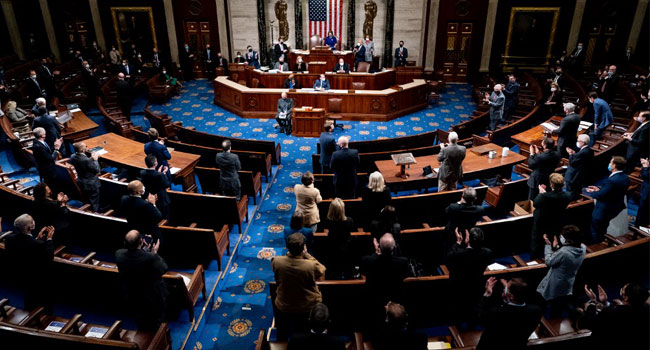 Republican and Democrats clap as House Minority Leader Kevin McCarthy (R-CA) commends Capitol Police and law enforcement for their work after Pro-Trump demonstrators stormed the Capitol in the House chamber on January 6, 2021 in Washington, D.C. Pool/Getty Images/AFP