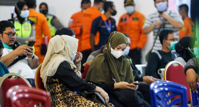 Missing Indonesia Plane Suspected To Have Crashed With 62 Passengers, Crew On Board Relatives of passengers on board missing Sriwijaya Air flight SJY182 wait for news at the Supadio airport in Pontianak on January 9, 2021, after contact with the aircraft was lost shortly after take-off from Jakarta. Louis ANDERSON / AFP