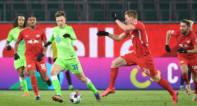 Wolfsburg's German midfielder Yannick Gerhardt (3rdL) and Leipzig's German defender Marcel Halstenberg vie for the ball during the German first division Bundesliga football match between VfL Wolfsburg and RB Leipzig in Wolfsburg, on January 16, 2021. FABIAN BIMMER / POOL / AFP