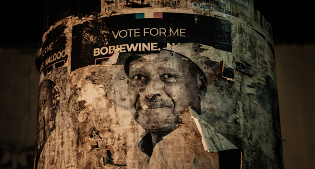 An old poster of Uganda's incumbent President Yoweri Museveni is seen on a an utility pole on the eve of Presidential and general elections on January 13, 2021, in Kampala, Uganda. YASUYOSHI CHIBA / AFP