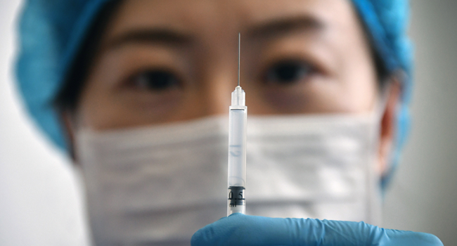A medical worker shows a syringe with the Sinovac Biotech vaccine against the COVID-19 coronavirus at a healthcare centre in Yantai, in eastern China's Shandong province on January 5, 2021. STR / AFP