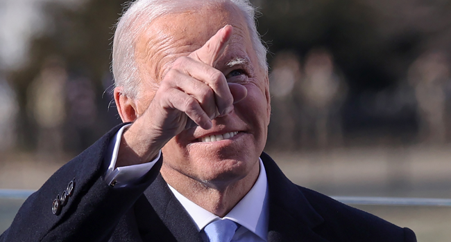 US President Joe Biden looks up into the crowd during his inauguration as the 46th President of the United States on the West Front of the US Capitol in Washington, DC on January 20, 2021. Biden was sworn in as the 46th president of the US. JONATHAN ERNST / POOL / AFP