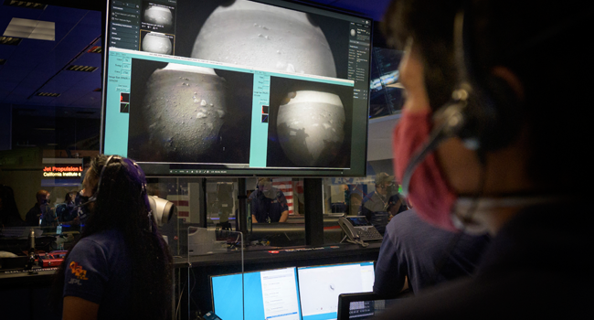 This NASA photo shows members of NASA’s Perseverance Mars rover team watching in mission control as the first images arrive moments after the spacecraft successfully touched down on Mars, on February 18, 2021, at NASA's Jet Propulsion Laboratory in Pasadena, California. Bill INGALLS / NASA / AFP