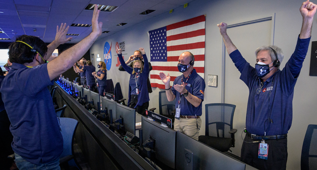 This NASA photo shows members of NASA’s Perseverance rover team as they react in mission control after receiving confirmation the spacecraft successfully touched down on Mars, on February 18, 2021, at NASA's Jet Propulsion Laboratory in Pasadena, California. Bill INGALLS / NASA / AFP