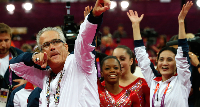 In this file photo taken on July 31, 2012, US women gymnastics team's coach John Geddert celebrates with the rest of the team after the US won gold in the women's team artistic gymnastics event at the London Olympic Games. AFP