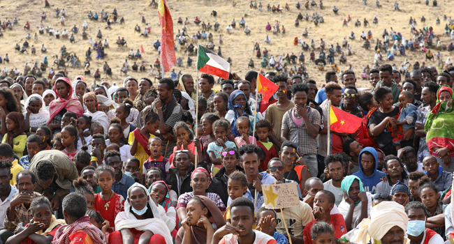 In this file photo taken on February 18, 2021 Ethiopian refugees gather to celebrate the 46th anniversary of the Tigray People's Liberation Front at Um Raquba refugee camp in Gedaref, eastern Sudan. Hussein Ery / AFP