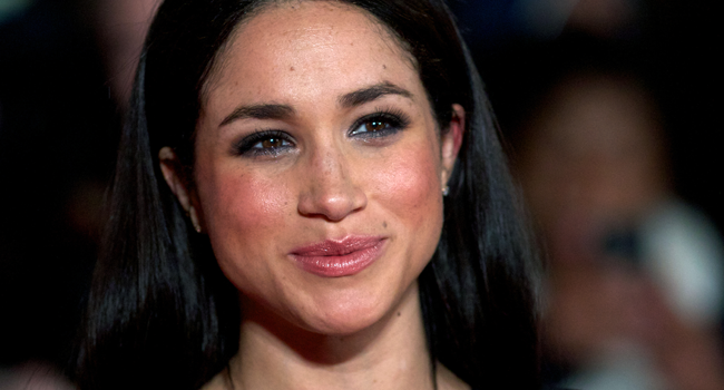In this file photo taken on November 11, 2013 American actress Meghan Markle poses for pictures on the red carpet upon arrival for the world premier of the film "The Hunger Games: Catching Fire" in Leicester Square, central London. ANDREW COWIE / AFP