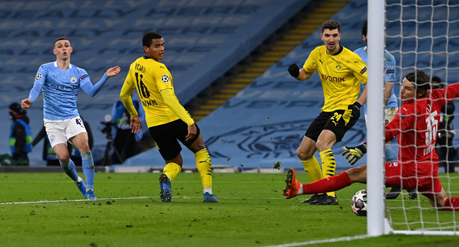 Manchester City's English midfielder Phil Foden (L) scores his team's second goal during the UEFA Champions League first leg quarter-final football match between Manchester City and Borussia Dortmund at the Etihad Stadium in Manchester, north west England, on April 6, 2021. Paul ELLIS / AFP