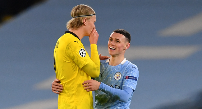 Manchester City's English midfielder Phil Foden (R) walks off the pitch with Dortmund's Norwegian forward Erling Braut Haaland after the UEFA Champions League first leg quarter-final football match between Manchester City and Borussia Dortmund at the Etihad Stadium in Manchester, north west England, on April 6, 2021. Paul ELLIS / AFP