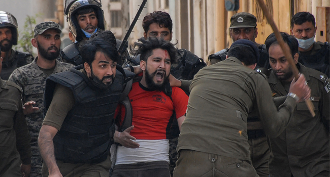 Policemen detain a supporter of Tehreek-e-Labbaik Pakistan (TLP) party during a protest against the arrest of their leader as he was demanding the expulsion of the French ambassador over depictions of Prophet Muhammad, in Rawalpindi on April 14, 2021. AFP