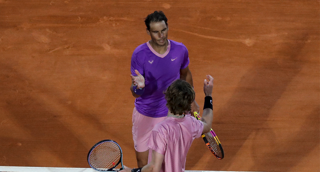 Spain's Rafael Nadal (Top) shakes hands with Russia's Andrey Rublev after their quarter final singles match on day seven of the Monte-Carlo ATP Masters Series tournament in Monaco on April 16, 2021. Valery HACHE / AFP