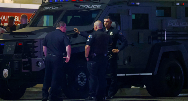 Police officers stand outside an office building where four people, including a child, were killed in a shooting on March 31, 2021 in Orange, California. Mario Tama/Getty Images/AFP