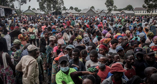 Residents displaced by the May 22, 2021 Mount Nyiragongo volcanic eruption wait to register to receive some aid distributed by a local politician and businessman in Goma on May 26, 2021.
