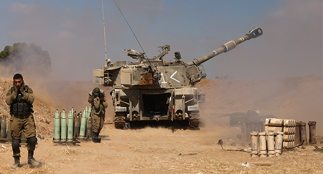 Israeli soldiers fire a 155mm self-propelled howitzer towards the Gaza Strip from their position near the southern Israeli city of Sderot on May 13, 2021. Menahem KAHANA / AFP