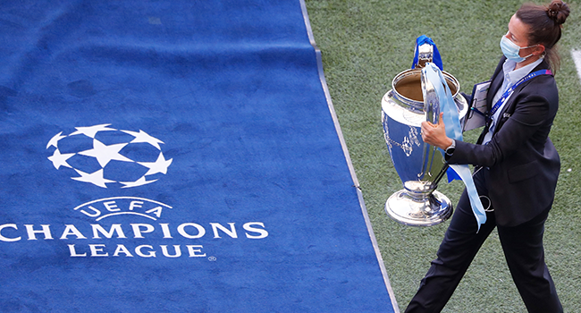 The trophy is carried pitch side ahead of the UEFA Champions League final football match between Manchester City and Chelsea at the Dragao stadium in Porto on May 29, 2021. SUSANA VERA / POOL / AFP