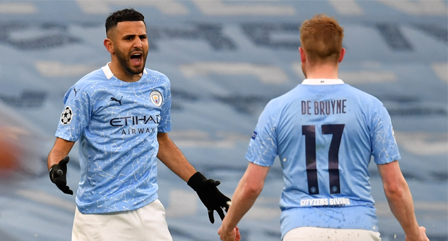 Manchester City's Algerian midfielder Riyad Mahrez (L) celebrates scoring the opening goal with Manchester City's Belgian midfielder Kevin De Bruyne during the UEFA Champions League second leg semi-final football match between Manchester City and Paris Saint-Germain (PSG) at the Etihad Stadium in Manchester, north west England, on May 4, 2021. Paul ELLIS / AFP