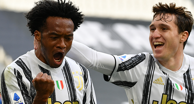 Juventus' Colombian midfielder Juan Cuadrado celebrates after scoring his first goal during the Italian Serie A football match Juventus vs Inter on May 15, 2021 at the Juventus stadium in Turin. Isabella BONOTTO / AFP