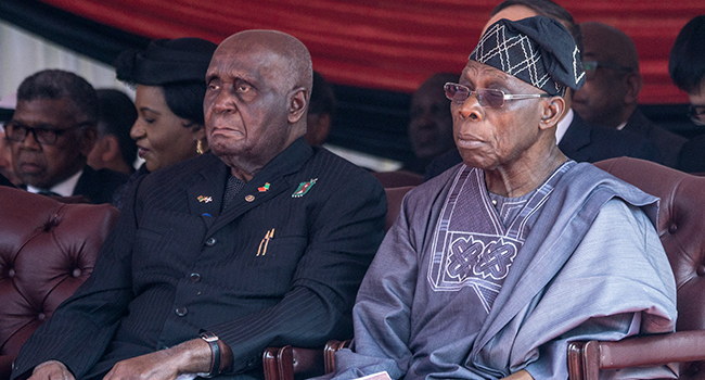 In this file photo taken on September 14, 2019 Former Zambian President Kenneth Kaunda (L) and former Nigerian President Olusegun Obasanjo (R) attend a farewell ceremony for late Zimbabwean President Robert Mugabe, held for family and heads of state at the National Sports Stadium in Harare. Zinyange Auntony / AFP