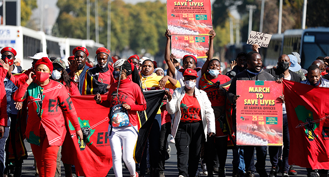 Economic Freedom Fighters (EFF) members chant and hold placards as they march to the South African Health Products Regulatory Authority (SAHPRA) offices in Pretoria, on June 25, 2021. Phill Magakoe / AFP