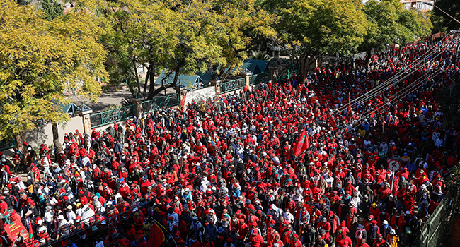 Economic Freedom Fighters (EFF) members chant as they march to the South African Health Products Regulatory Authority (SAHPRA) offices in Pretoria, on June 25, 2021. Phill Magakoe / AFP