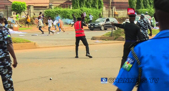 A policeman shoots at protesters in Abuja on June 12, 2021. Sodiq Adelakun/Channels Television