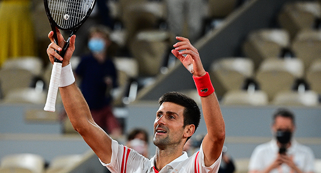 Serbia's Novak Djokovic celebrates after winning against Spain's Rafael Nadal at the end of their men's singles semi-final tennis match on Day 13 of The Roland Garros 2021 French Open tennis tournament in Paris on June 11, 2021. MARTIN BUREAU / AFP