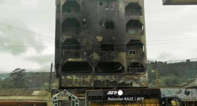 his photo taken on June 16, 2017 in Bamenda shows a hotel destroyed by a fire, allegedly attributed to a radical separatist movement demanding the independence of the anglophone region from the rest of francophone Cameroon. REINNIER KAZE / AFP