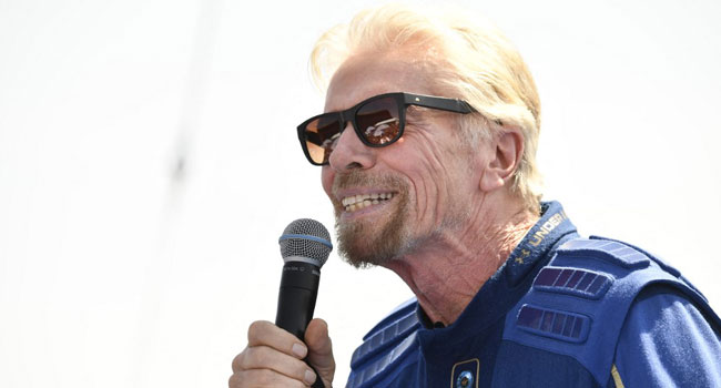 Sir Richard Branson speaks on stage with other crew members, after they flew into space aboard a Virgin Galactic vessel, a voyage he described as the "experience of a lifetime" -- and one he hopes will usher in an era of lucrative space tourism at Spaceport America, near Truth and Consequences, New Mexico on July 11, 2021. AFP