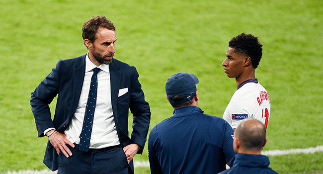 England's coach Gareth Southgate (L) speaks with England's forward Marcus Rashford (R) ahead of going on during the UEFA EURO 2020 final football match between Italy and England at the Wembley Stadium in London on July 11, 2021. JOHN SIBLEY / POOL / AFP