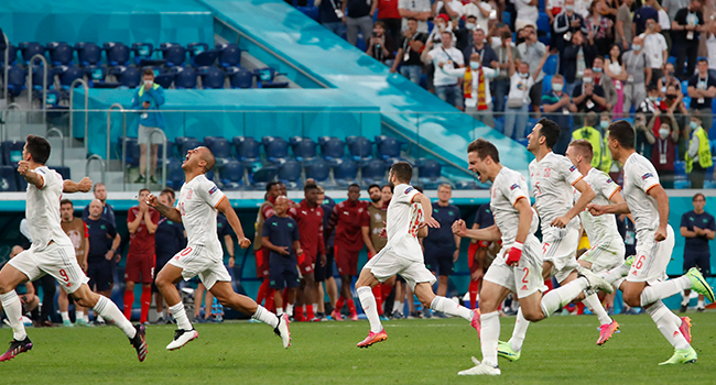 Spain's players celebrate after winning during the UEFA EURO 2020 quarter-final football match between Switzerland and Spain at the Saint Petersburg Stadium in Saint Petersburg on July 2, 2021. MAXIM SHEMETOV / POOL / AFP