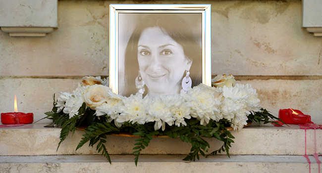 In this file photo taken on October 19, 2017 Flowers and tributes lay at the foot of the Great Siege monument in Valletta, which has been turned into a temporary shrine for Maltese journalist and blogger Daphne Caruana Galizia (picture) who was killed by a car bomb outside her home three days before. Matthew Mirabelli / AFP