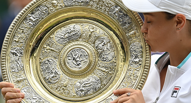 Australia's Ashleigh Barty kisses the winner's Venus Rosewater Dish trophy after winning her women's singles match against Czech Republic's Karolina Pliskova on the twelfth day of the 2021 Wimbledon Championships at The All England Tennis Club in Wimbledon, southwest London, on July 10, 2021. Glyn KIRK / AFP