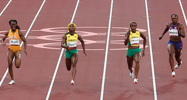 (L to R) Ivory Coast's Marie-Josee Ta Lou, Jamaica's Shelly-Ann Fraser-Pryce, Jamaica's Elaine Thompson-Herah and daniels compete in the women's 100m final during the Tokyo 2020 Olympic Games at the Olympic Stadium in Tokyo on July 31, 2021. Giuseppe CACACE / AFP