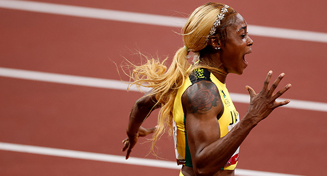 Jamaica's Elaine Thompson-Herah celebrates after winning the women's 100m final and setting a new Olympic Record during the Tokyo 2020 Olympic Games at the Olympic Stadium in Tokyo on July 31, 2021. Odd ANDERSEN / AFP