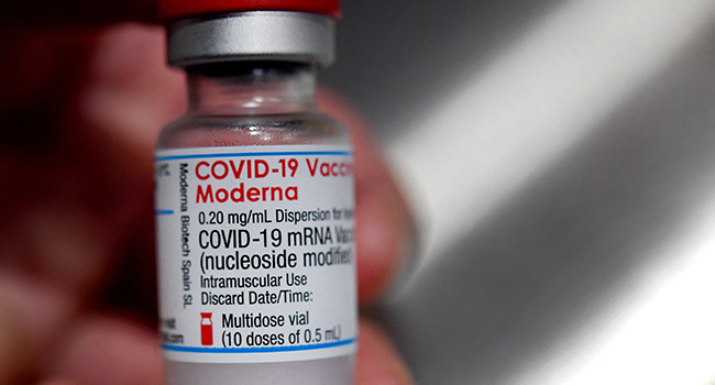 In this file photograph taken on June 29, 2021, a medical official holds a vial of the Moderna Covid-19 vaccine in Quimper, western France. Fred TANNEAU / AFP