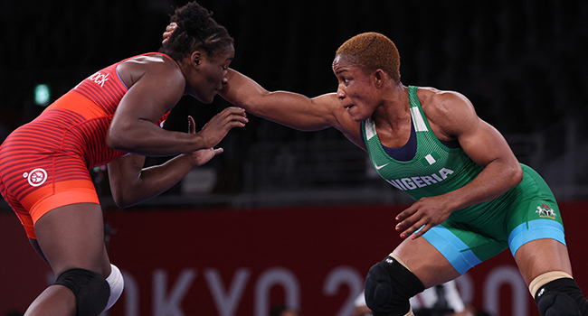 USA's Tamyra Marianna Stock Mensah (red) wrestles Nigeria's Blessing Oborududu in their women's freestyle 68kg wrestling final match during the Tokyo 2020 Olympic Games at the Makuhari Messe in Tokyo on August 3, 2021. Jack GUEZ / AFP