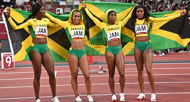 First-placed (from L) Jamaica's teammates Shericka Jackson, Briana Williams, Shelly-Ann Fraser-Pryce and Elaine Thompson-Herah celebrate after wining the women's 4x100m relay final during the Tokyo 2020 Olympic Games at the Olympic Stadium in Tokyo on August 6, 2021. Andrej ISAKOVIC / AFP