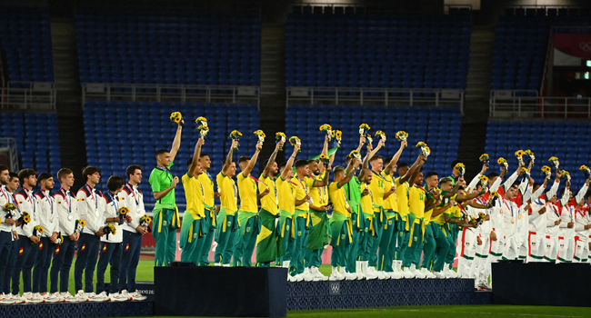 Brazil's gold medallists (C) celebrate on the podium during the medal ceremony of the Tokyo 2020 Olympic Games men's football competition at Yokohama International Stadium in Yokohama, Japan, on August 7, 2021. LOIC VENANCE / AFP