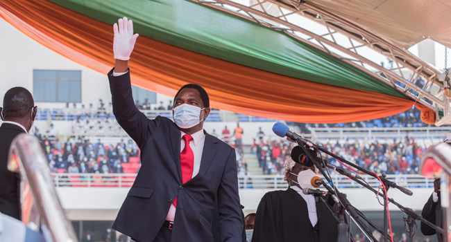 Newly elected Zambia President Hakainde Hichilema waves at the crowd after taking oath of office at the Heroes Stadium in Lusaka on August 24, 2021. Salim DAWOOD / AFP