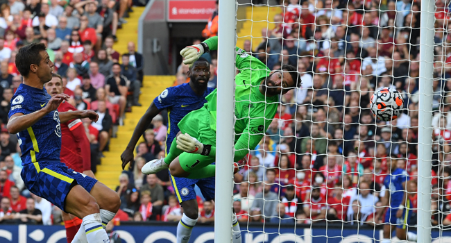 Liverpool's Brazilian goalkeeper Alisson Becker (C) cannot reach the ball as a header from Chelsea's German midfielder Kai Havertz (not pictured) opens the scoring in the English Premier League football match between Liverpool and Chelsea at Anfield in Liverpool, north west England on August 28, 2021. Paul ELLIS / AF