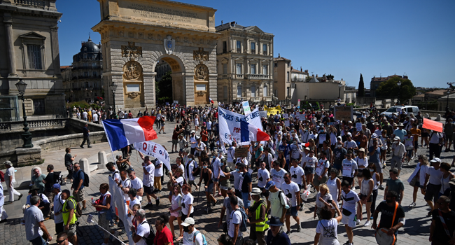 Demonstrators take part in a national day of protest against the compulsory Covid-19 vaccination for certain workers, and the mandatory use of the health pass called for by the French government to access most public spaces, in Montpellier, southern France, on August 28, 2021. Sylvain THOMAS / AFP