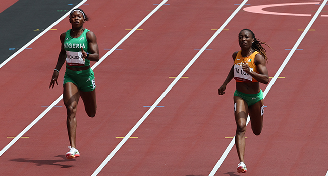 Ivory Coast's Marie-Josee Ta Lou (R) wins the women's 200m heat ahead of Nigeria's Nzubechi Grace Nwokocha during the Tokyo 2020 Olympic Games at the Olympic Stadium in Tokyo on August 2, 2021. Giuseppe CACACE / AFP