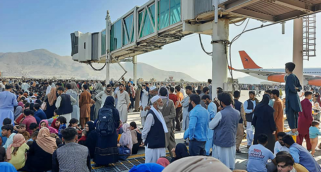 Afghans crowd at the tarmac of the Kabul airport on August 16, 2021, to flee the country as the Taliban were in control of Afghanistan after President Ashraf Ghani fled the country and conceded the insurgents had won the 20-year war. AFP