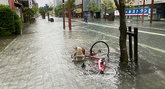 A flooded street is seen in Saga city on August 14, 2021, as torrential rain triggered floods and landslides in western Japan. STR / JIJI PRESS / AFP
