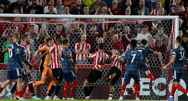 Brentford's Danish midfielder Christian Norgaard (C #6) scores their second goal during the English Premier League football match between Brentford and Arsenal at Brentford Community Stadium in London on August 13, 2021. Adrian DENNIS / AFP