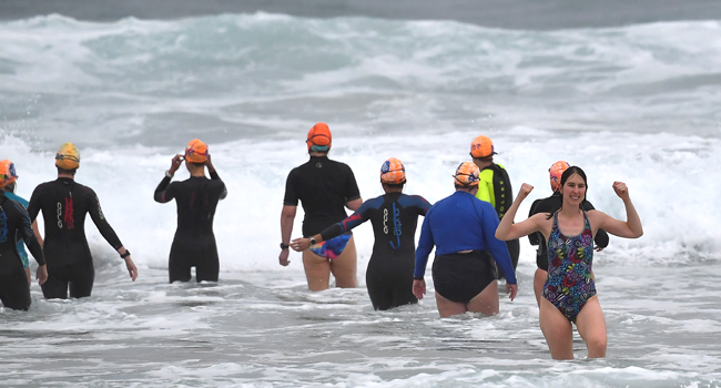 Residents enjoy big waves on the Bondi beach at the end of 106-days lockdown in Sydney on October 11, 2021, as a long coronavirus lockdown lifted in Australia's largest city. Saeed KHAN / AFP